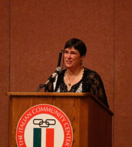 Cheryl speaks at a podium