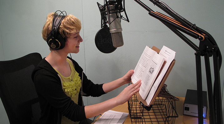 A volunteer in the recording booth at ABLE.