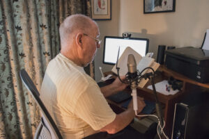 Audio volunteer Dave Raasch recording at home.